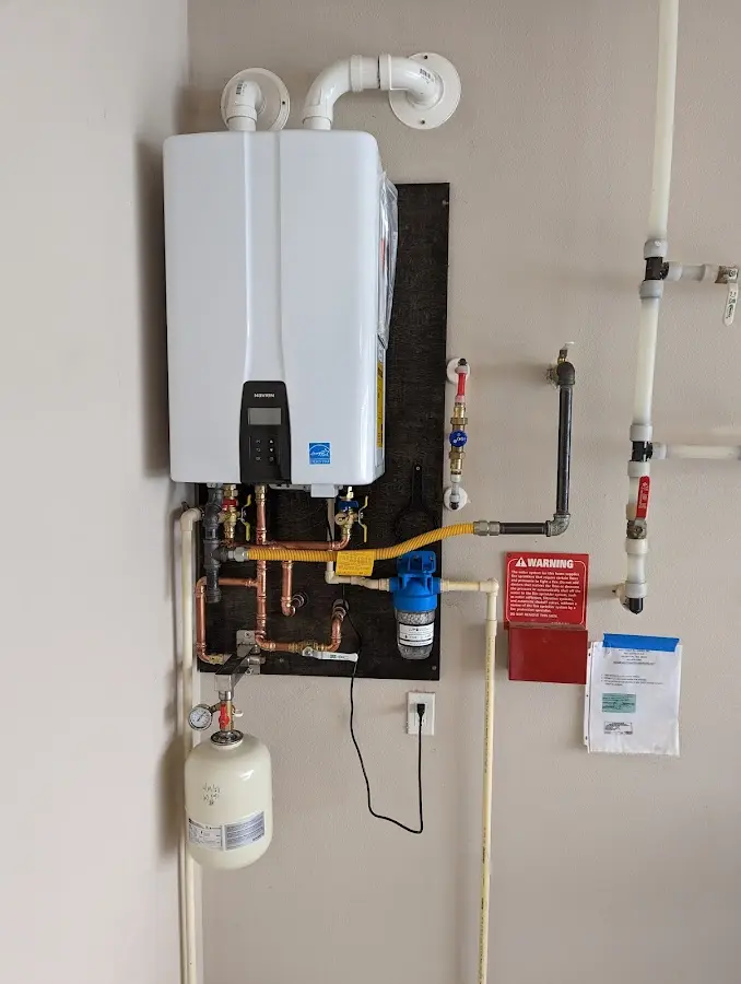 Professional plumber installing copper piping in a Ely home